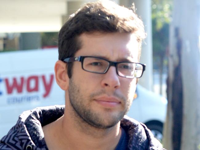 Jakob Thornton, 22, the young driver who severed the foot of one police officer and injured another when he allegedly ploughed his car into them at an RBT while while texting walks out of Bankstown Police Station where he has to report for bail conditions with his girlfriend. Photo Jeremy Piper