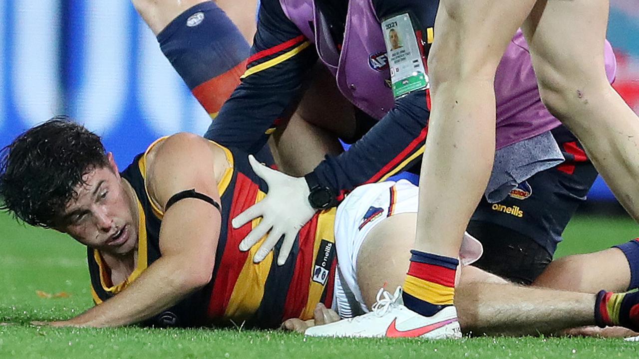 Ned McHenry was floored by a Scott Lycett tackle. Picture: Sarah Reed/AFL Photos /Getty Images