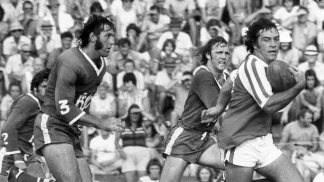 Redcliffe’s Alan Nunan tries to run away from Vic Wieland.