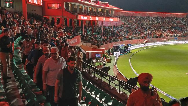 Spectators leave after the Indian Premier League (IPL) Twenty20 cricket match between Punjab Kings and Delhi Capitals was abandoned due to a significant technical failure. (Photo by Shammi MEHRA / AFP)
