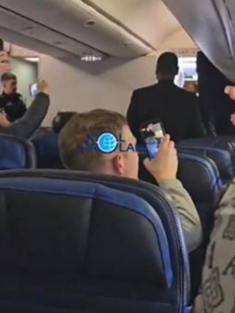 Passengers appeared to cheer as a man was led away in Maine.