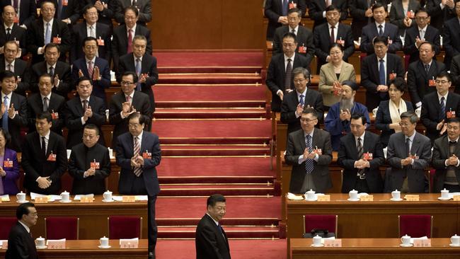 Chinese President Xi Jinping,centre, arrives with Premier Li Keqiang, left, for the opening session of the Chinese People's Political Consultative Conference in Beijing's Great Hall of the People on March 3, 2018. Picture: AP