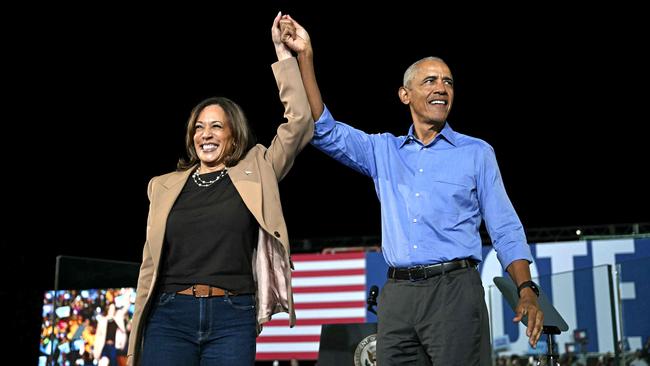 Barack Obama hold hands with Kamala Harris during a campaign rally in Clarkston, Georgia on October 24. Picture: Drew Angerer/AFP