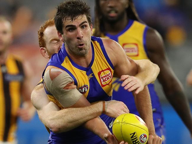 PERTH, AUSTRALIA - AUGUST 16: Andrew Gaff of the Eagles looks to handball while being tackled by Conor Glass of the Hawks during the round 12 AFL match between the West Coast Eagles and the Hawthorn Hawks at Optus Stadium on August 16, 2020 in Perth, Australia. (Photo by Paul Kane/Getty Images)