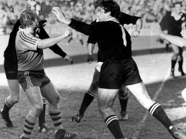 Wallaby Peter Horton (L) and All Black Gary Knight exchange blows during the match.