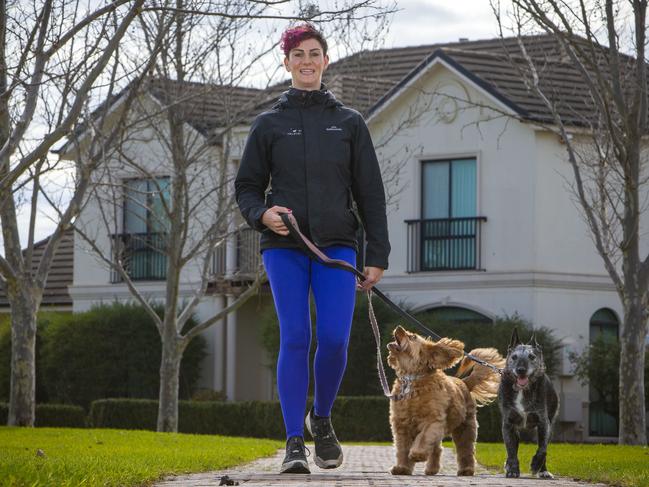 Brooke Walmsley from Happy Pet Helpers walking Phoebe, a cavoodle and Murphy, a terrier mix, in Hillcrest Park. Picture: Emma Brasier