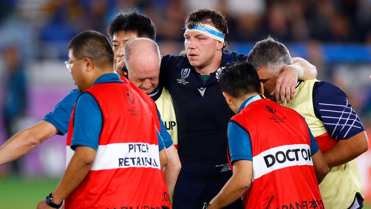 Scotland's flanker Hamish Watson carried off the pitch after a controversial tackle. (Photo by Odd ANDERSEN / AFP)