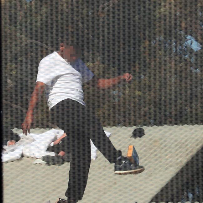 Inmates from the Frank Baxter Juvenile corrections centre Kariong taunt police from the roofs of various buildings. Some are armed with poles tennis rackets ect. Picture: John Grainger