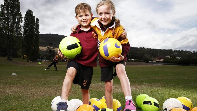 Dominic College grade 1 students Jameson King, 6 of Montrose and Charlotte Berry of Glenlusk ahead of the Football Tasmania release State of Play report. Picture: Zak Simmonds