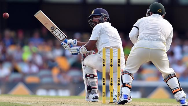 India's Murali Vijay (L) plays a sweep shot on day one of the 2nd Test match between Australia and India at The Gabba in Brisbane on December 17, 2014. AFP PHOTO / SAEED KHAN IMAGE RESTRICTED TO EDITORIAL USE - STRICTLY NO COMMERCIAL USE