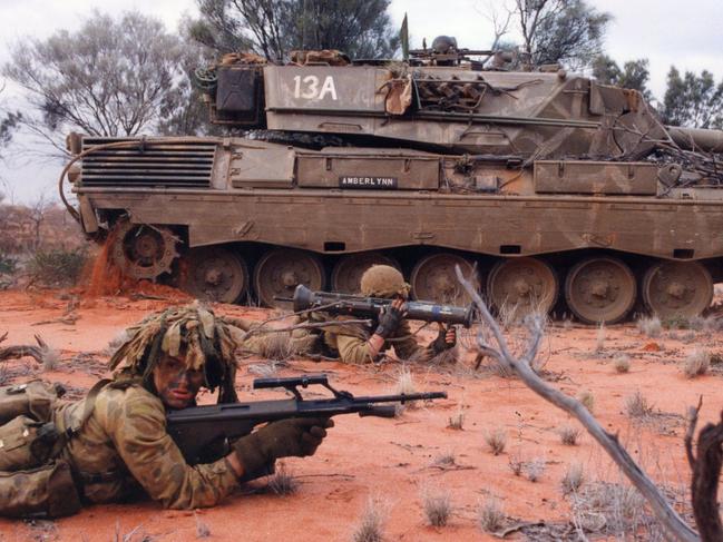 Australian Army training. Exercise Desert Tiger at Woomera Range area. It was a 1 Brigade exercise consisting of the 5/7 Battalion, Royal Australian Regiment (Mounted Infantry), 8/12 medium battery artillery and 26 transport squadron, all from Sydney, NSW. Live fire attack on enemy position. Troops in foreground are from 5/7 RAR, background in Leopard tank from 1 Armoured Regiment 24 Jun 1994. (Pic by Lance Corporal Geoff Cox)