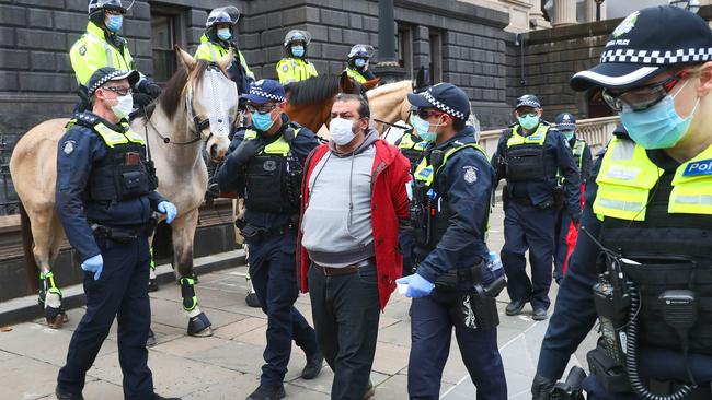 9/08/20 A man is arrested after be became agitated with Police outside Victorian parliament where an anti-mask protest was planned. He was chanting "no forced vaccinations". Aaron Francis/The Australian