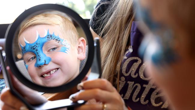 Nate Evans, 5 gets his face painted at The Country Club in Gledswood Hills. Cost of living is seeing families scale back spending on toys, games and activities, but there's still ways to keep kids busy without spending a cent these school holidays. Picture: Damian Shaw