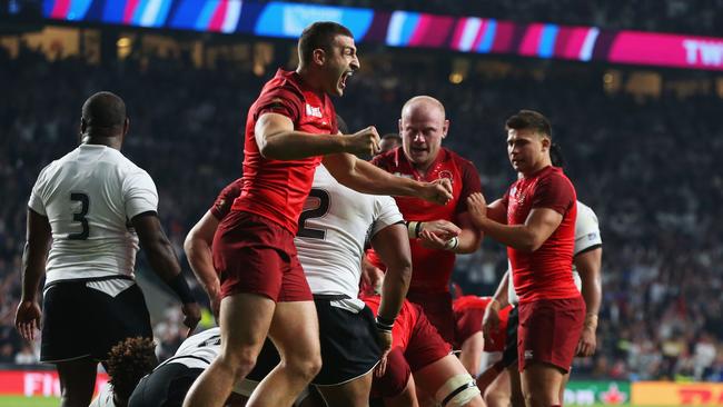 Jonny May of England celebrates with team mates after being awarded a penalty try.