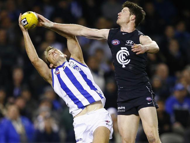 Carlton’s Sam Rowe tries his best to spoil Kangaroo forward Drew Petrie. Picture: Michael Klein