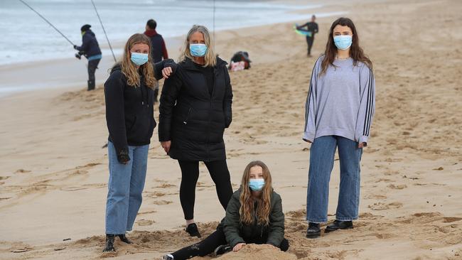 The Cooper family wear their mask while at the beach in Portsea. Picture: Alex Coppel.