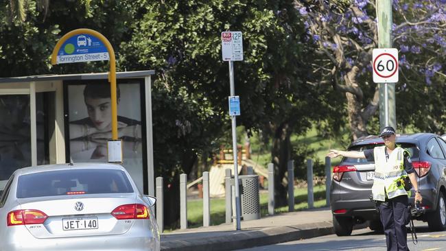 Police with radar catching speeders in a 40km school zone.