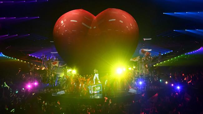 A giant heart shape is displayed as Lebanese-born British singer-songwriter Mika performs during an interlude at the final of the Eurovision Song contest 2022.