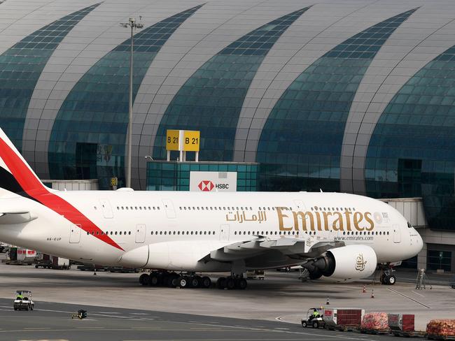 (FILES) In this file photo taken on March 24, 2020 An Emirates Airbus A380-842 aircraft is pictured grounded at Dubai international Airport in Dubai after Emirates suspended all passenger operations amid the COVID-19 coronavirus pandemic in Dubai. - The crisis due to the coronavirus might give the final blow to the Airbus A380, once a symbol of the frantic development of air transport but then considered as not enough profitable by airlines now on their knees. (Photo by KARIM SAHIB / AFP)