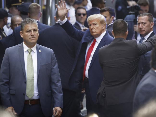 Donald Trump waves as he arrives at the Manhattan Criminal Court for his arraignment hearing. Picture: Getty Images via AFP