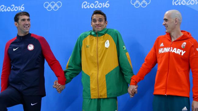 Joint silver medalists, from left, Michael Phelps, Chad le Clos of South Africa and Laszlo Cseh of Hungary celebrate winning a silver in the men's 100m butterfly. Picture: Clive Rose/Getty Images