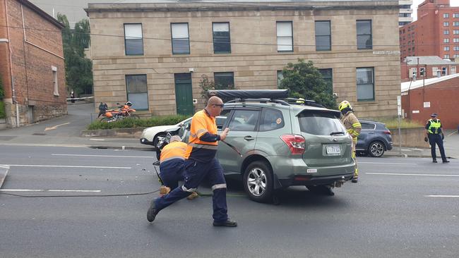 Car on its side on Davey St, Hobart.