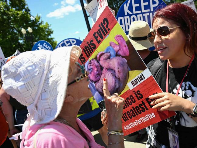 An anti-abortion activist (R) argues with reproductive rights activists during a demonstration in front of the US Supreme Court in Washington, DC, on June 24, 2024. (Photo by Jim WATSON / AFP)