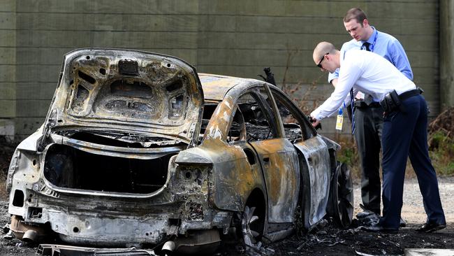 A burnt-out car near the scene of the shooting.