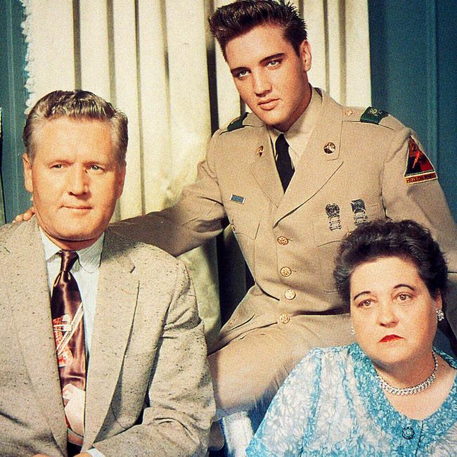 Elvis Presley dress in his US Army uniform with his father Vernon and mother Gladys.