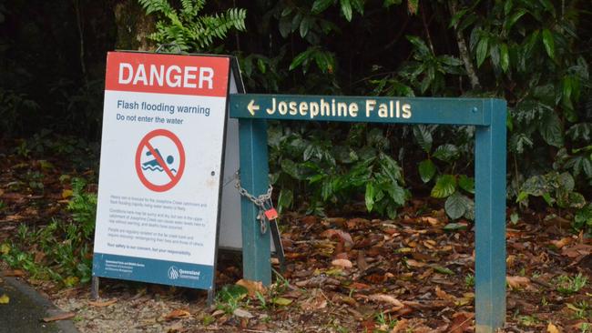 Signs at the entrance to Josephine Falls in 2018 warn tourists of the dangers of rising floodwaters. Pic: ELISABETH CHAMPION