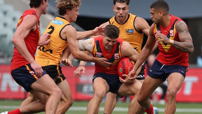South Australia’s Tom Lewis tries to break clear in the state game against Western Australia at Adelaide Oval on Saturday. Picture: David Mariuz/SANFL