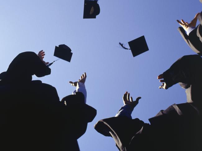 Generic image of university students. University students throwing mortar boards in the air.