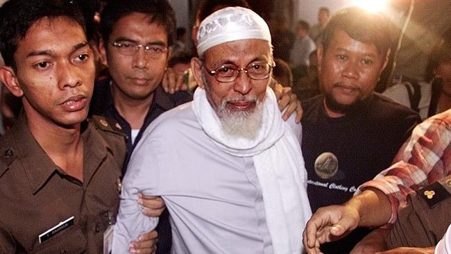 Militant Islamic preacher Abu Bakar Bashir, center, is pictured here in February of 2003 being escorted by guards at the prosecutors office in Jakarta.
