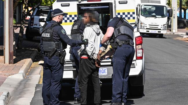 A man is arrested and taken away by police after the brawl. Picture: Brenton Edwards