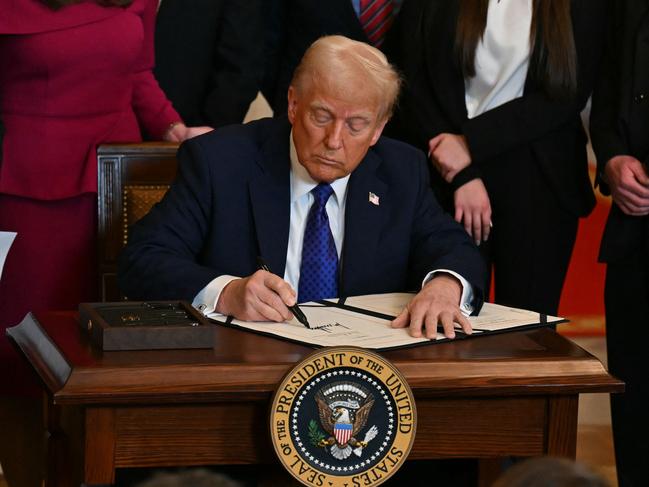 US President Donald Trump signs the Laken Riley Act in the East Room of the White House. Picture: AFP