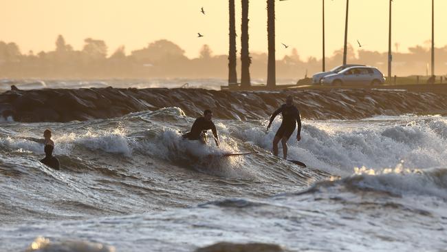 Despite the restrictions, surfers were spotted in the water at Williamstown beach. Picture: Josie Hayden