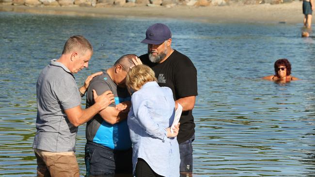 Tom Tate is getting baptised at Evandale Lake during a combined churches service. Pastor Sue Baynes and helpers Marshall Gray and Rodger Baynes. Picture Mike Batterham