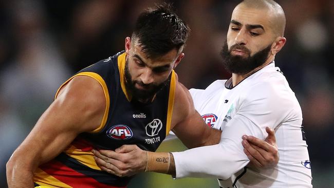 Wayne Milera and Adam Saad jostle for possession at the Adelaide Oval on Saturday night.