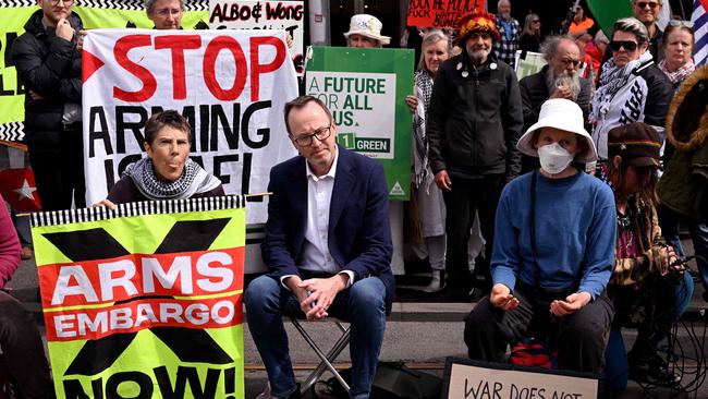 Greens senator David Shoebridge listens to protesters outside the Land Forces 2024 arms fair in Melbourne on September 13, 2024. (Photo by William WEST / AFP)