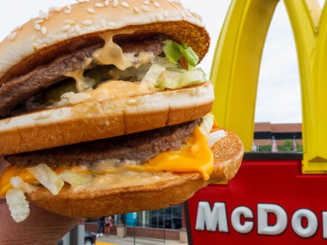 (FILES) This file photo taken on August 10, 2015 shows a McDonald's Big Mac, held up near the golden arches at a McDonalds's in Centreville, Virginia.      McDonald's reported higher second-quarter profits July 25, 2017 behind strong comparable sales in key markets, including the United States, where the chain has launched new products and focused on customer service.  Net income for the quarter ending June 30 was $1.4 billion, up 28 percent from the year-ago period in results that easily topped analyst expectations. Shares rose sharply in pre-market trading. / AFP PHOTO / Paul J. RICHARDS