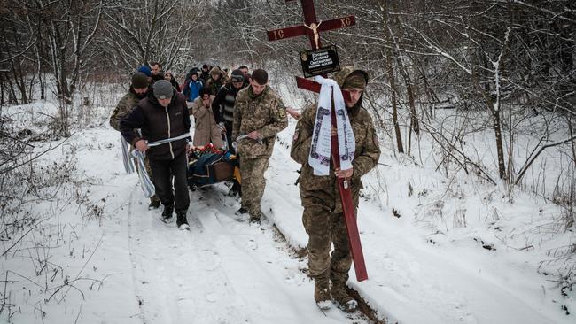 Friends carry the coffin of a Ukrainian soldier killed in the besieged eastern town of Bakhmut. Picture: AFP