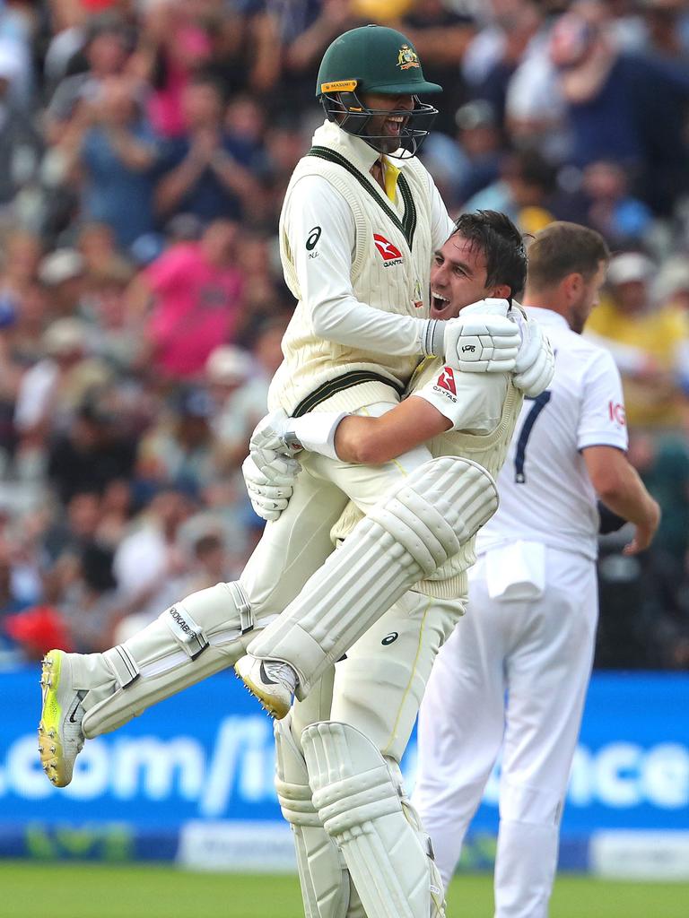 Lyon celebrates the win with Pat Cummins. Picture: AFP