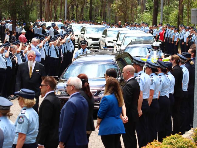 A hearse passes the guard of honour at the memorial service with full police honours for constables Rachel McCrow and Matthew Arnold at Brisbane Entertainment Centre. Picture: David Clark