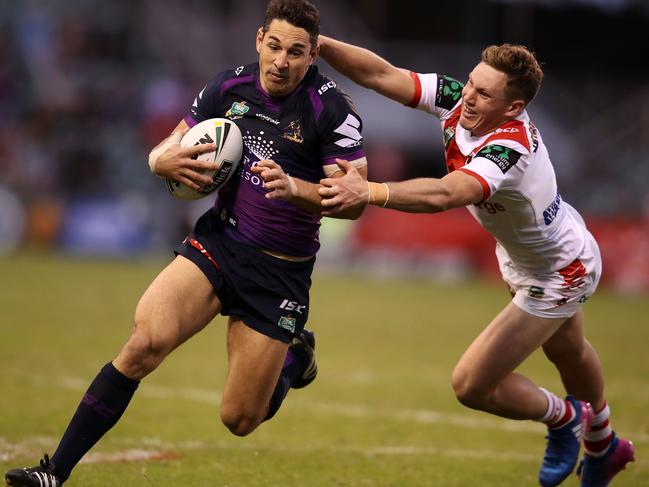 WOLLONGONG, AUSTRALIA - APRIL 30:  Billy Slater of the Storm evades the tackle of Kurt Mann of the Dragons during the round nine NRL match between the St George Illawarra Dragons and the Melbourne Storm at WIN Stadium on April 30, 2017 in Wollongong, Australia.  (Photo by Mark Kolbe/Getty Images)