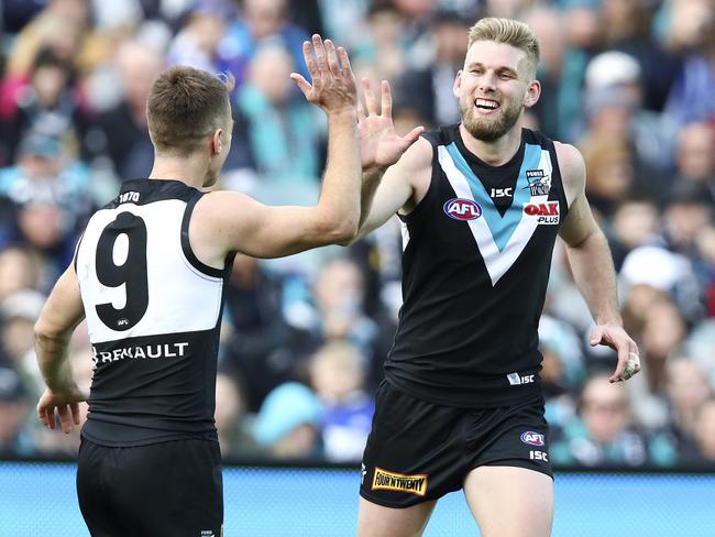 Jackson Trengove celebrates a goal with Robbie Gray.