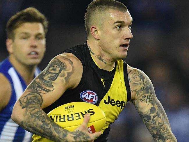 Dustin Martin of the Tigers (centre) is seen in action during the Round 11 AFL match between the North Melbourne Kangaroos and the Richmond Tigers at Etihad Stadium in Melbourne, Saturday, June 3, 2017. (AAP Image/Julian Smith) NO ARCHIVING, EDITORIAL USE ONLY