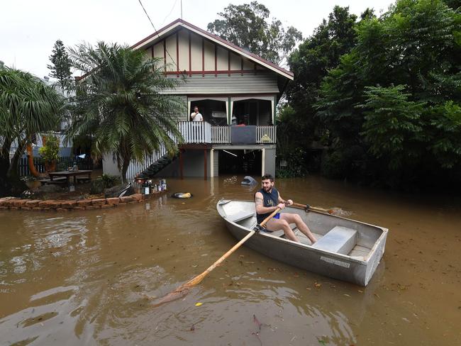 Lennon Bartlett rows a boat to his parents house next door to where he lives in central Lismore, New South Wales, Friday, March 31, 2017. The Wilsons River breached its banks early morning flooding the far-northern NSW town. (AAP Image/Dave Hunt) NO ARCHIVING