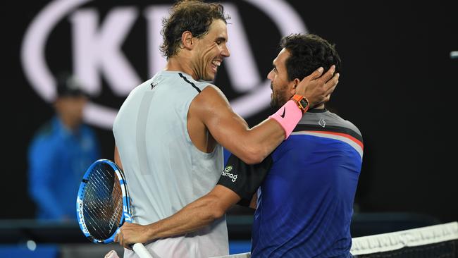 Rafael Nadal embraces Victor Estrella Burgos after their first-round match.