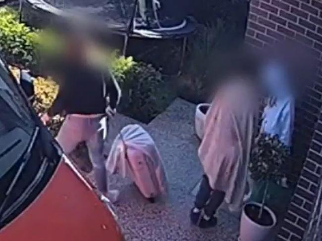 CCTV footage shows the guests, a woman and three children leaving the house with what appears to be Mr Dawe's belongings.  Picture: 9 News Adelaide