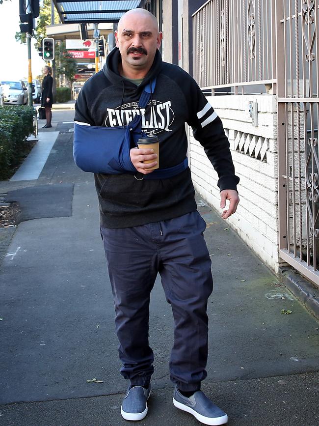 Khaled Merhi, with his arm in a sling, outside his Surry Hills home that was raided by police on July 29. Picture: Jane Dempster